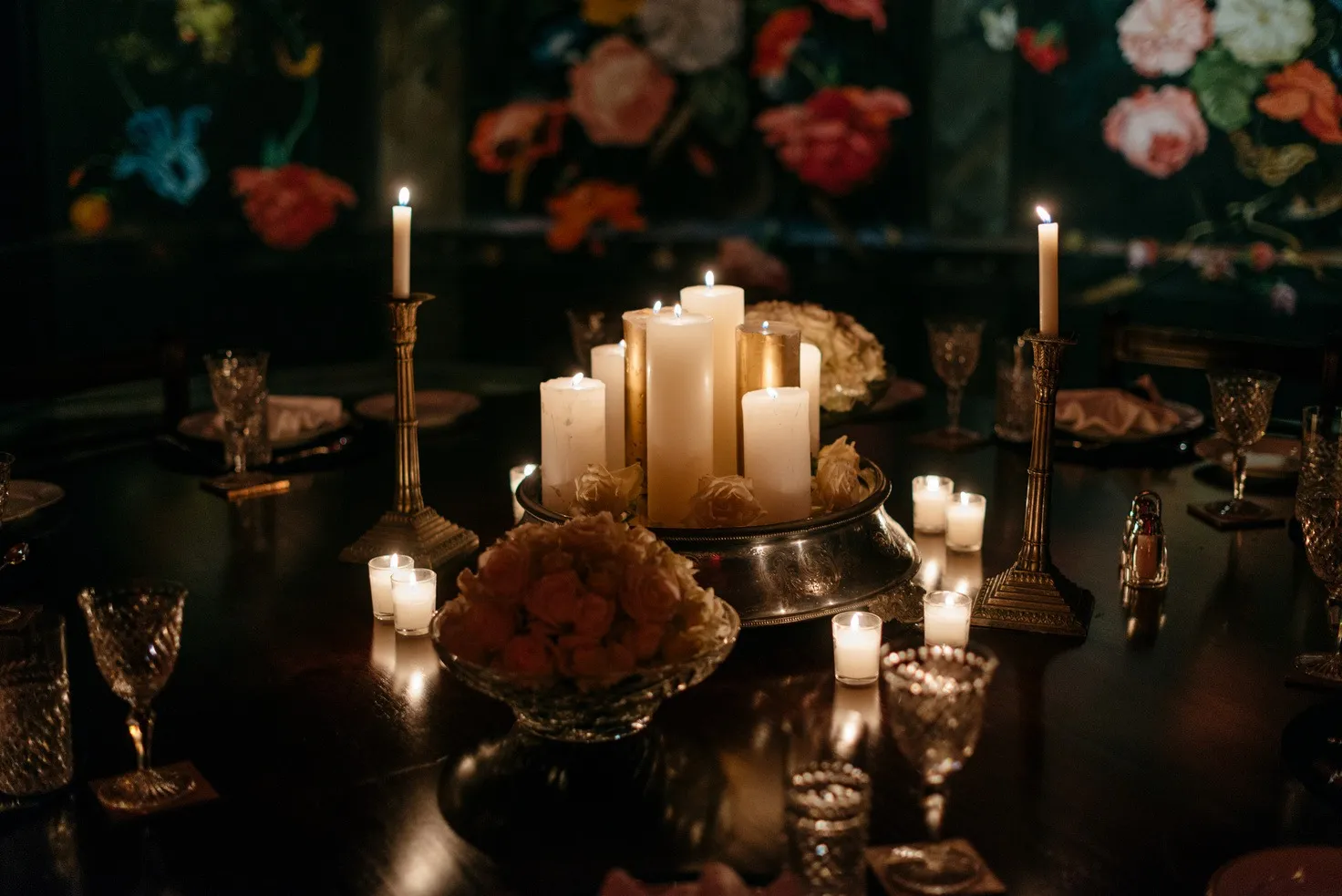 A dark table lit by candles.